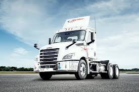 ASCargo logistics truck on a Western U.S. highway at sunset